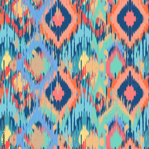 A vibrant modern Ikat bohemian seamless pattern featuring overlapping geometric diamond and zigzag shapes. The design stands out with its distinct fuzzy, brush-stroke edges that mimic traditional hand