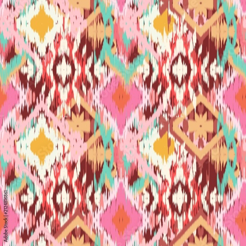 A vibrant modern Ikat bohemian seamless pattern featuring overlapping geometric diamond and zigzag shapes. The design stands out with its distinct fuzzy, brush-stroke edges that mimic traditional hand