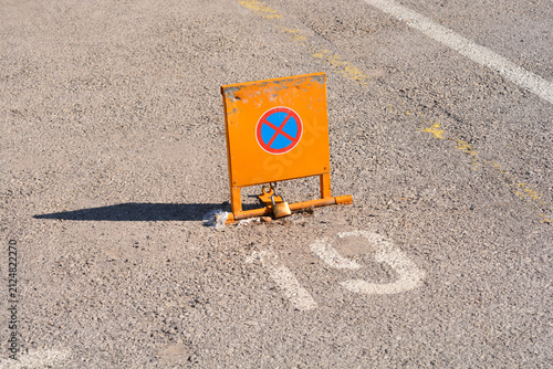 Принти на полотні An eye level view of a locked orange yellow metal folding parking barrier with a