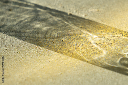 Bild auf Leinwand A narrow beam of sunlight and acrid glare cutting the concrete floor
