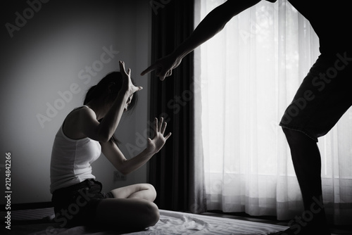 Obraz na płótnie Woman and man in a tense conflict with a defensive gesture, representing relationship crisis, domestic conflict awareness, emotional distress, respect, communication, safety, prevention, equality