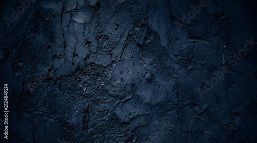 Dark blue abstract background with rough stone texture and shadows
