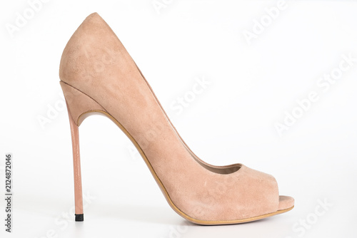Elegant beige suede high heel pump shoe with peep toe on white studio background