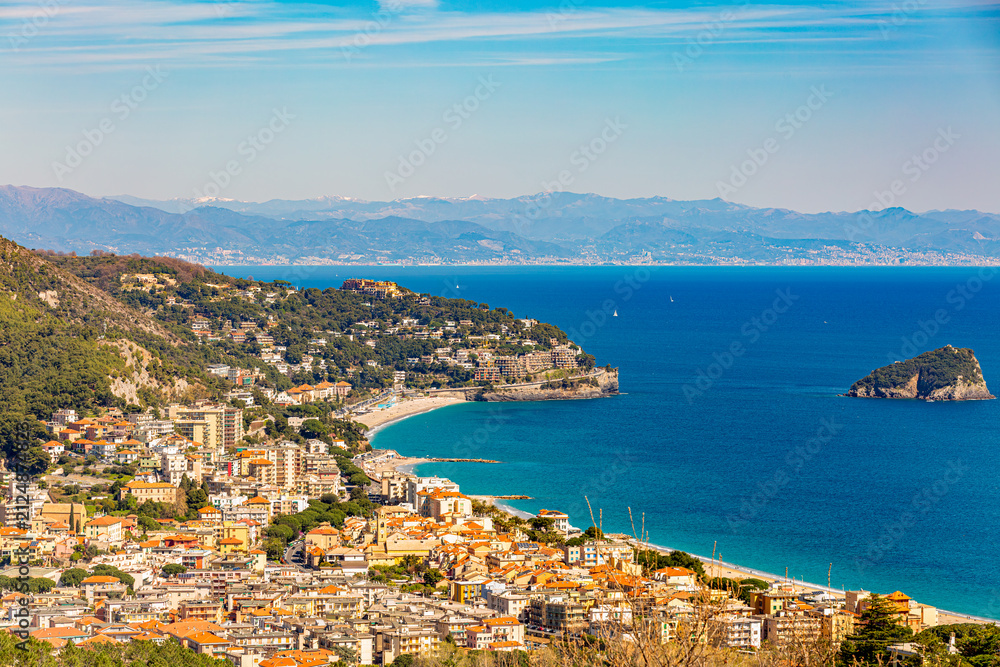 Fototapeta premium Aerial panoramic view of the coast of Spotorno, Bergeggi Island, Torre del Mare, Liguria, province of Savona, Italy. Riviera dei Fiori. Western Riviera. Ligurian Sea