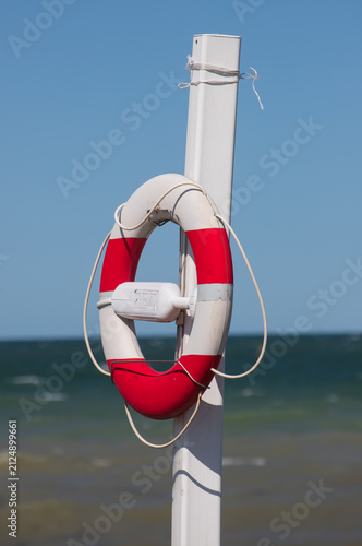 Summer Beach Scene with Lifebuoy Near the Sea