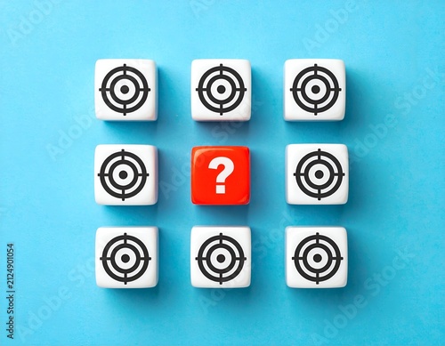 Nine cubes, eight targets & one question mark, arranged on blue background