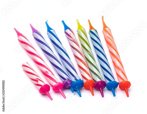 Close-up of colorful swirled birthday candles arranged diagonally on white