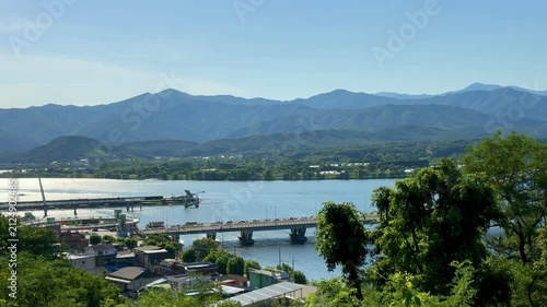 Beautiful aerial view capturing the cityscape of of Chuncheon with Soyanggang river view and the bridge. Mountains, big road and residential apartments buildings and beautiful green hills from afar