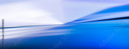 Abstract blue and white pattern created by light and reflection on a surface