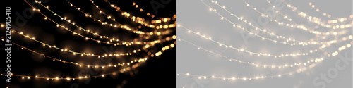 Obraz na plátně Diagonally draped golden string lights on black and transparent backdrop
