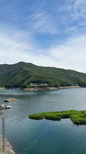 Soyang River Multipurpose Dam in Chuncheon, South Korea, under a clear blue sky. Beautiful landscape and mountain