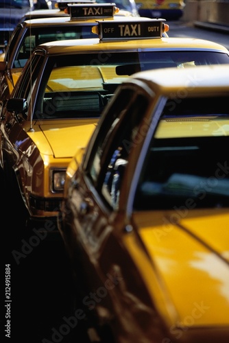Fotografie Row of Yellow Taxis Lined Up in City Street