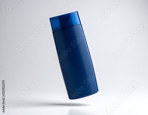 Sleek, navy blue plastic bottle with a transparent blue cap, suspended against a light grey background