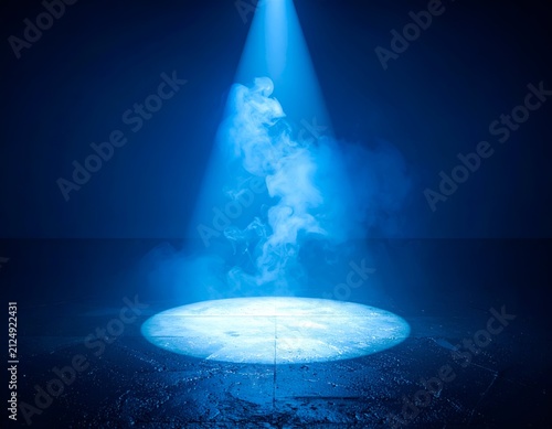 Bright blue spotlight illuminating swirling vapor on a dark, textured surface