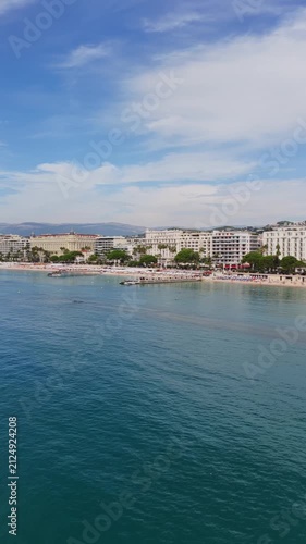 Aerial view of sunny Cannes coastline with Mediterranean sea and sandy beach.