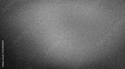 Gray textured background shows a smooth surface with subtle variations in color and light