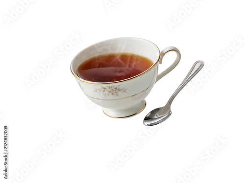 A delicate porcelain teacup filled with steaming hot tea rests on a matching saucer with a silver spoon. The elegant design and warm beverage create a classic tea-time ambiance.