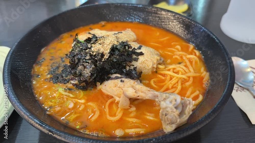Delicious Korean spicy chicken noodles or dakguksu on a bowl in restaurant