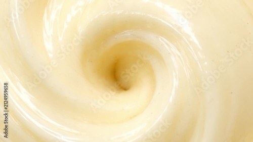 Abstract Vanilla Cream Swirl Background with Glossy Smooth Texture, Rotating Spiral Dessert Pattern, Full Frame Macro Dairy Surface for Product Packaging and Advertising