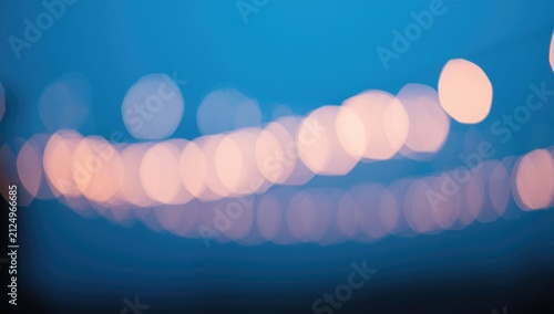 Abstract Bokeh Light Orbs Against a Blue Background at Dusk