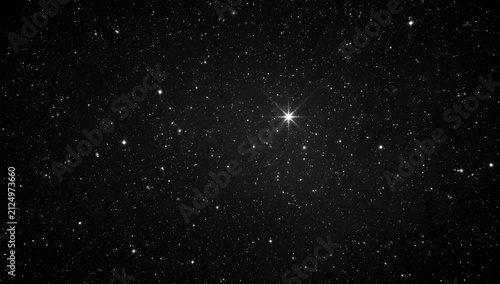 Starry Night Sky with Bright Star in Black Space
