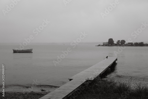 Wooden pier and boat on calm water