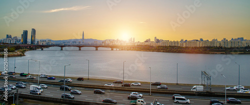 SEOUL SOUTH KOREA - November 22, 2025: Panoramic of Lotte Tower with bridge railway transport over the han river and city town landscape on golden sky cuold clear before sunset