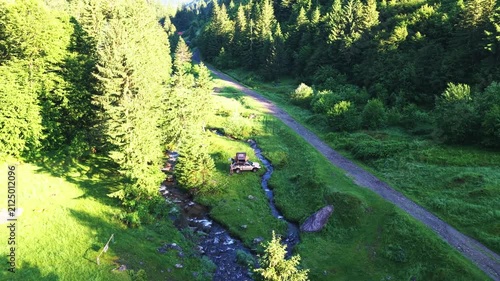 Adventurous overlanding camper exploring mountainous green forest