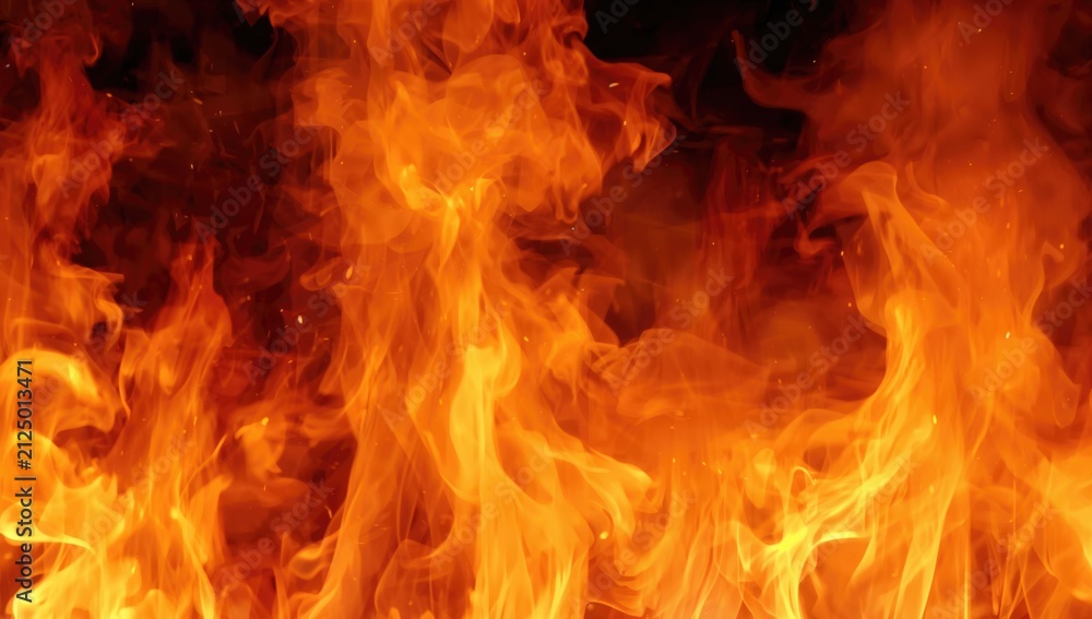 Fototapeta premium Flames Dancing in a Dark Background with Intense Orange Glow