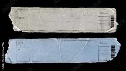 Two torn worn paper labels isolated on black background