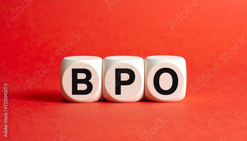 Three white cubes placed side by side against bright red background, each cube printed with single black letter forming acronym “BPO,” visually symbolizing business process outsourcing, relevant in bu