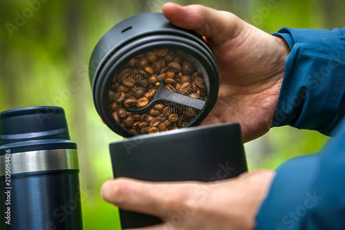 Opening vacuum coffee canister with coffee beans before outdoor coffee brewing