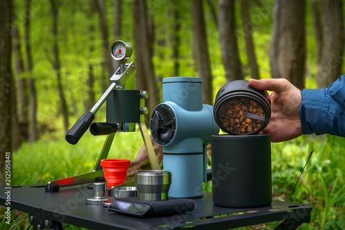 Outdoor coffee setup with portable espresso maker and opening vacuum coffee canister