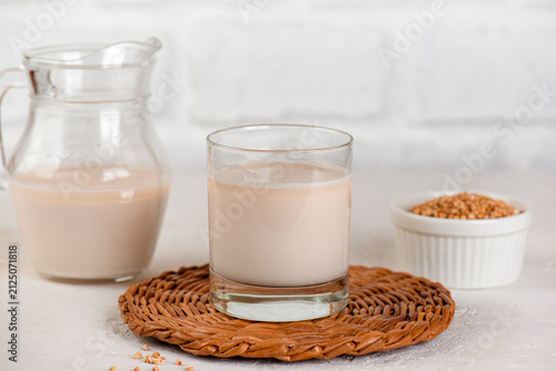 Buckwheat plant milk with green buckwheat seeds on light background, clean eating concept