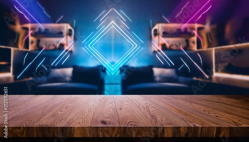 wooden tabletop mockup for gaming product display with blurred modern room background and neon geometric light shapes
