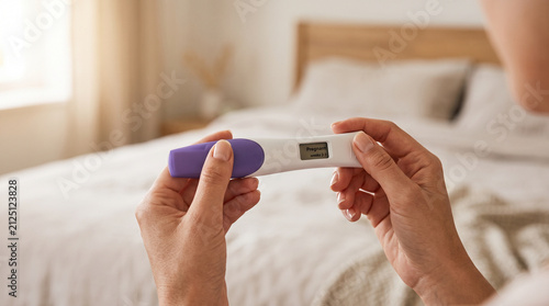 Woman using pregnancy test at home, representing early pregnancy detection, motherhood, and reproductive health awareness.