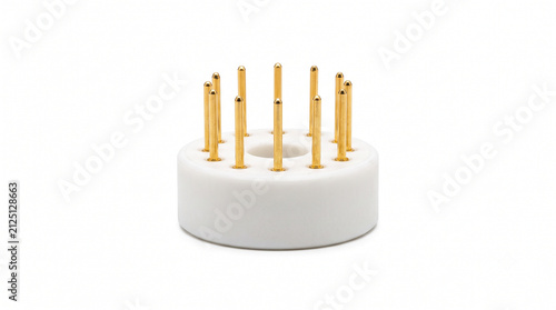 Macro of vacuum tube base contact pins. Array of gold-plated wire pins protruding from a heavy white ceramic socket base. Analog audio hardware on white.