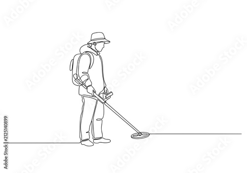 Metal detection specialist searching ground with detector