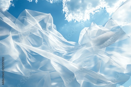 Translucent Fabric Billowing Against a Blue Sky with Clouds