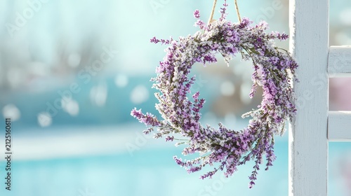 Beautiful floral wreath adorned with purple flowers hangs gracefully against soft blue background, evoking serene and tranquil atmosphere