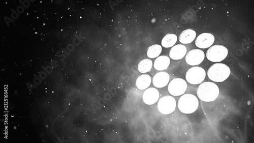 Spotlight shining through smoke and falling snow, creating a dramatic cinematic background. Perfect for winter, Christmas, New Year, stage, concert and festive visual effects.