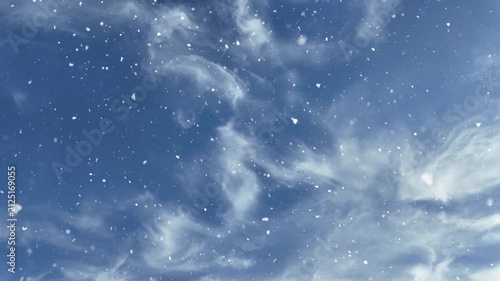Falling snow against a blue sky with soft white clouds. Perfect for winter, Christmas, New Year, seasonal backgrounds and festive designs.