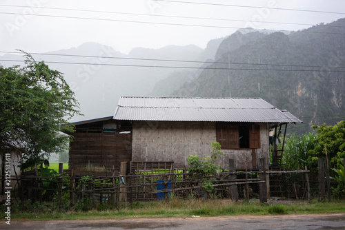 Traditional rural house in Kong Lor Village surrounded by limestone mountains in Khammouane Province, Laos