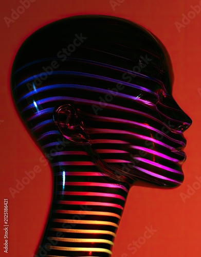 A glossy black sculpted head displays vibrant, illuminated horizontal stripes