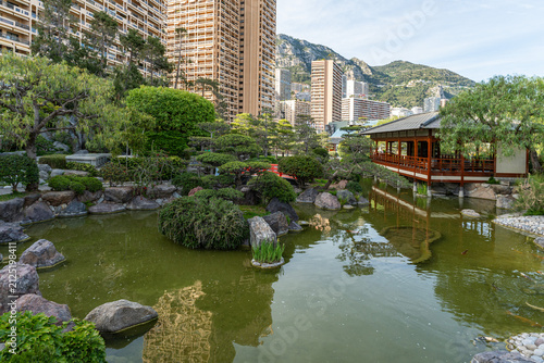 Japanese Garden pond and pavilion framed by highrise Monaco architecture