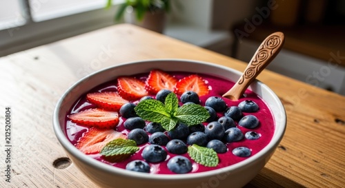 Vibrant Acai Bowl Topped with Fresh Strawberries and Blueberries.