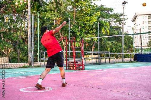Konstfotografi Focused male Sepak takraw player stands in a athletic defensive stance, concentr
