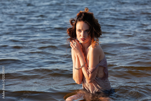 Nude Woman Standing In Water Waves