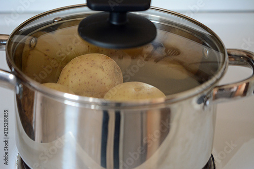 Potato's in a hot pat with a lid glass lid.