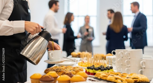 Professional Waiter Pouring Coffee at a Corporate Business Event Buffet with People Networking in Background